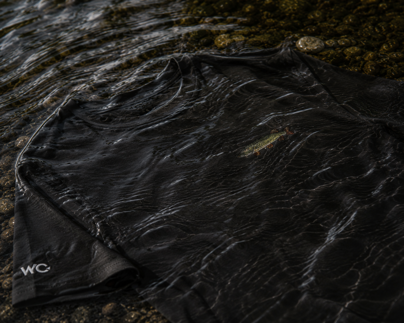 Partial view of a dark WearYourCatch garment in shallow water